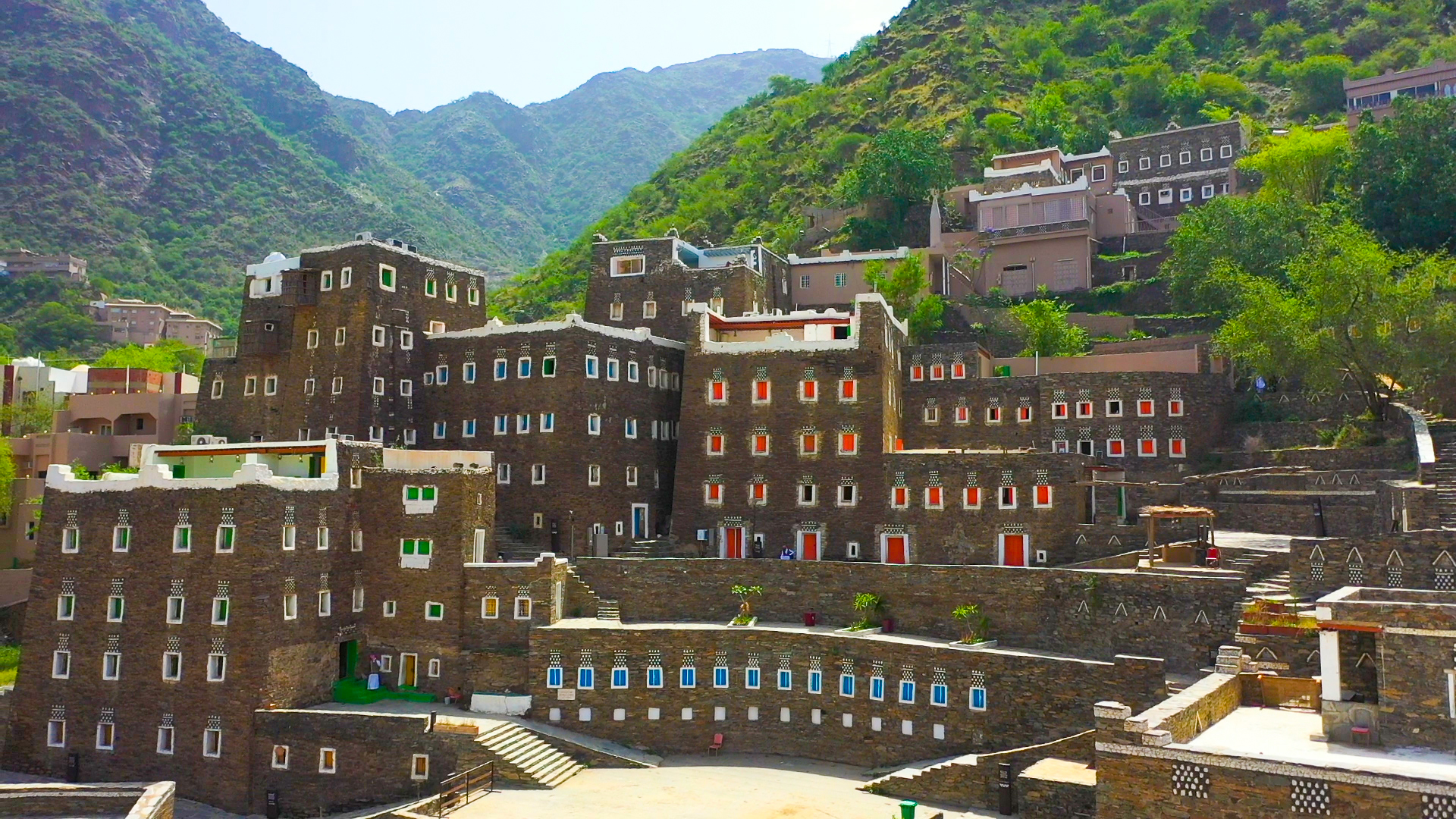 Multi-storey stone heritage towers of Rijal Almaa with colourful window frames in the Asir Mountains, Saudi Arabia